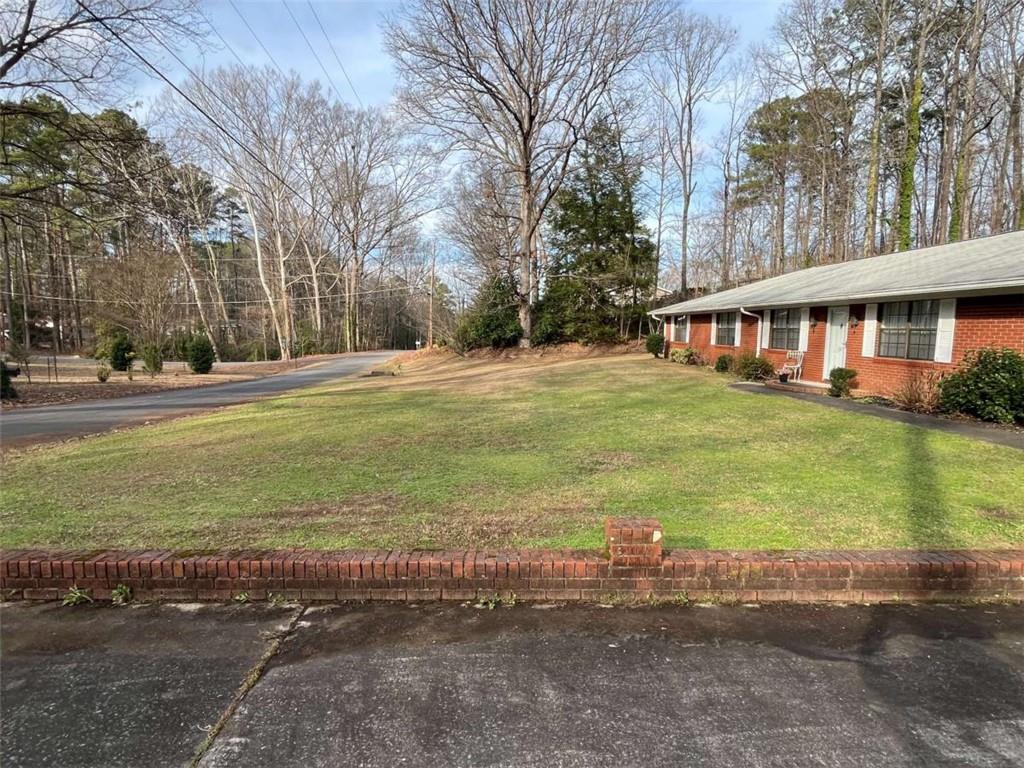 33 East Kenora Drive Southwest Rome, GA 30165 - Photo 27 of 30 a front view of house with yard and trees around