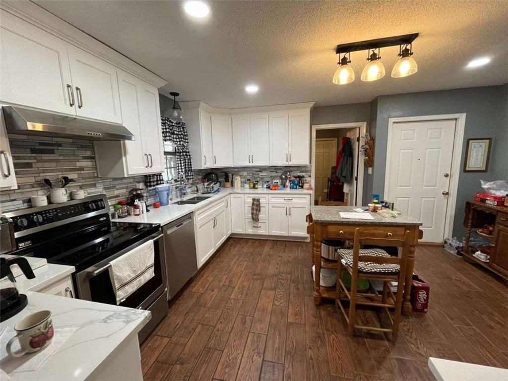 33 East Kenora Drive Southwest Rome, GA 30165 - Photo 5 of 30 a kitchen with a table chairs stove and cabinets