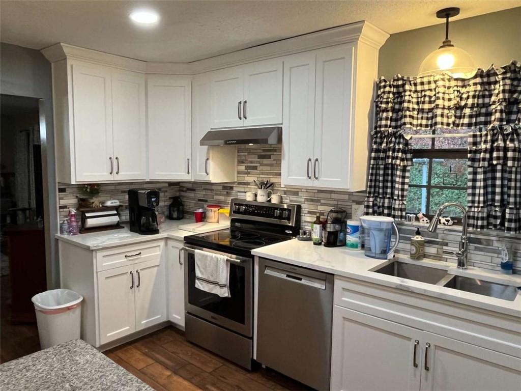 33 East Kenora Drive Southwest Rome, GA 30165 - Photo 7 of 30 a kitchen with a white cabinets and white appliances