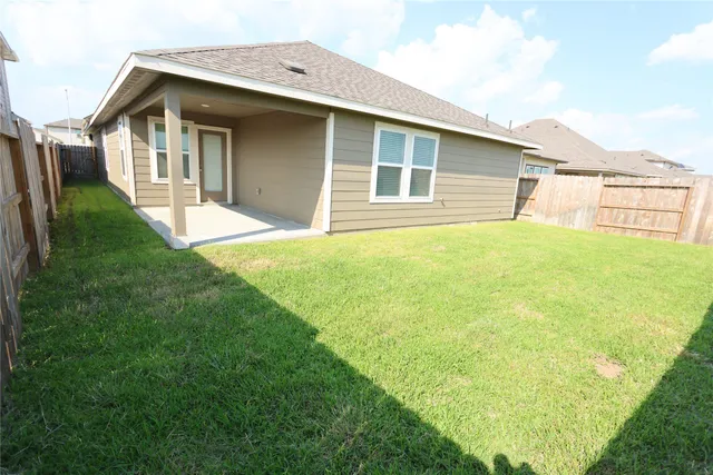 a front view of a house with yard and green space