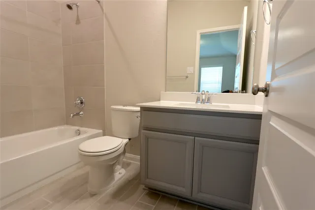 a bathroom with a sink toilet vanity and bathtub