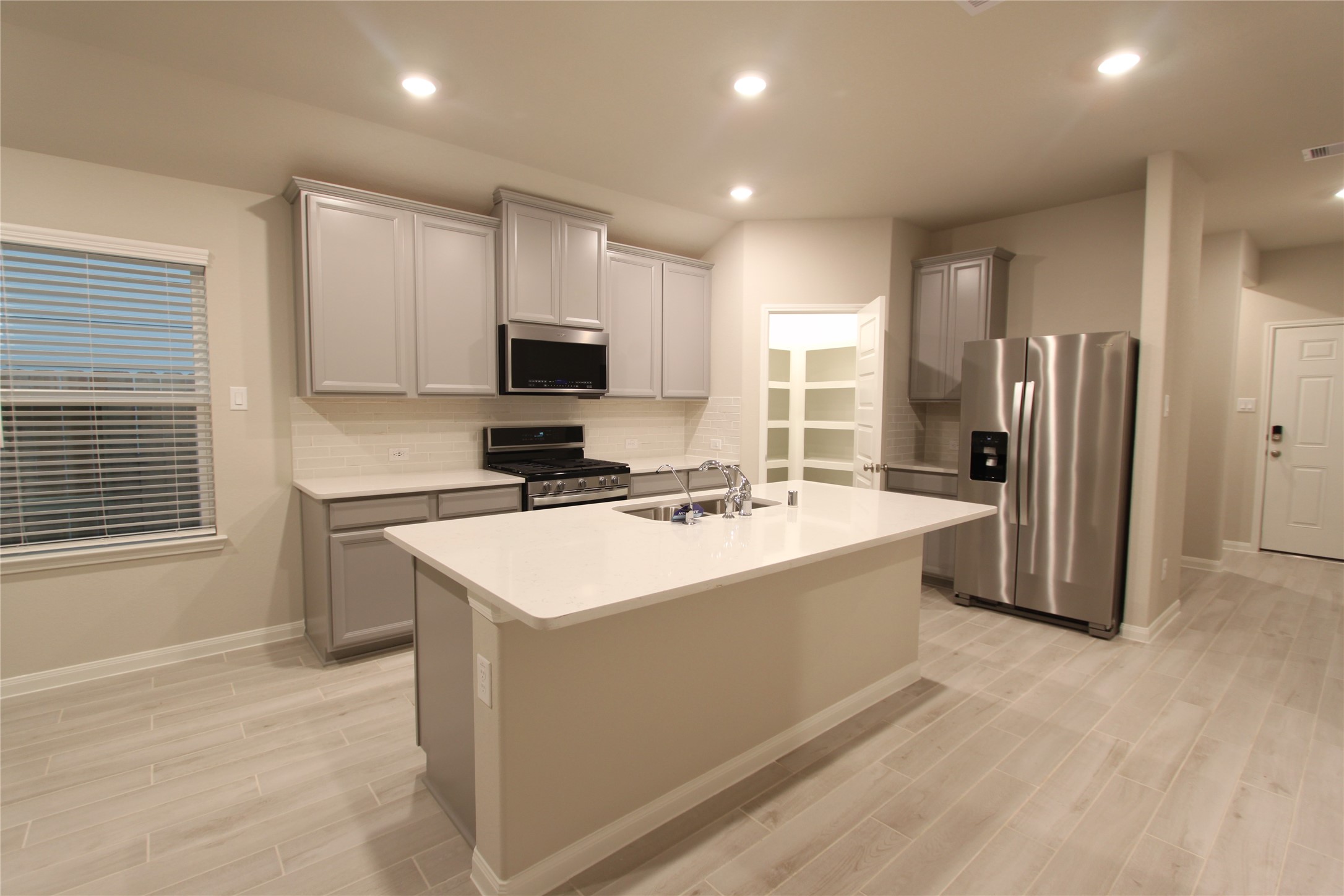906 Pismo Lane Rosharon, TX 77583 - Photo 4 of 15 a kitchen with stainless steel appliances granite countertop a sink stove refrigerator and cabinets