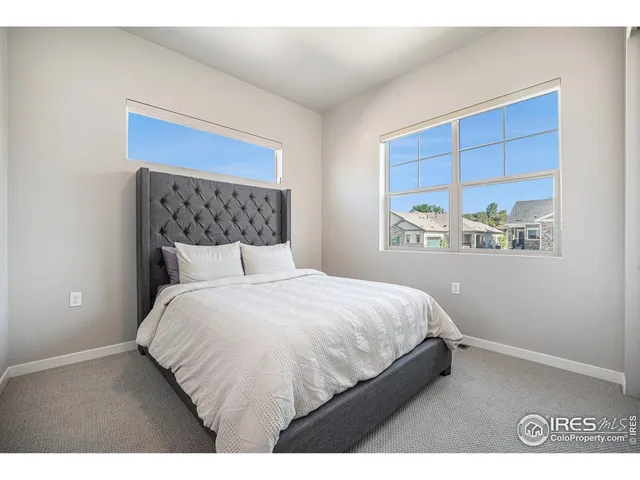 a bedroom with a bed and a night stand