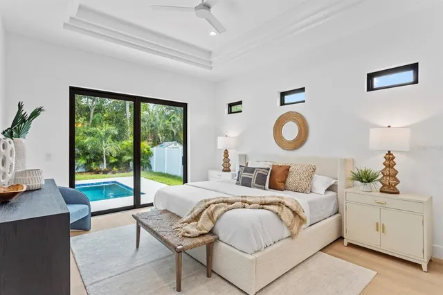 a bedroom with bed and a large window