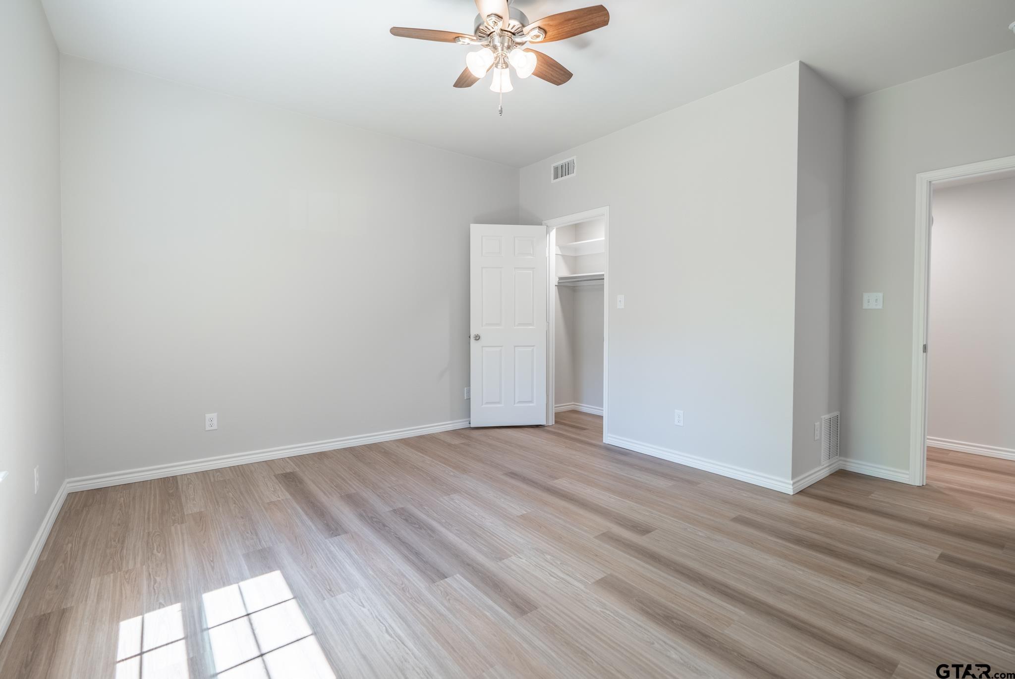 233 Harrison Street Longview, TX 75601 - Photo 23 of 44 wooden floor in an empty room with a window