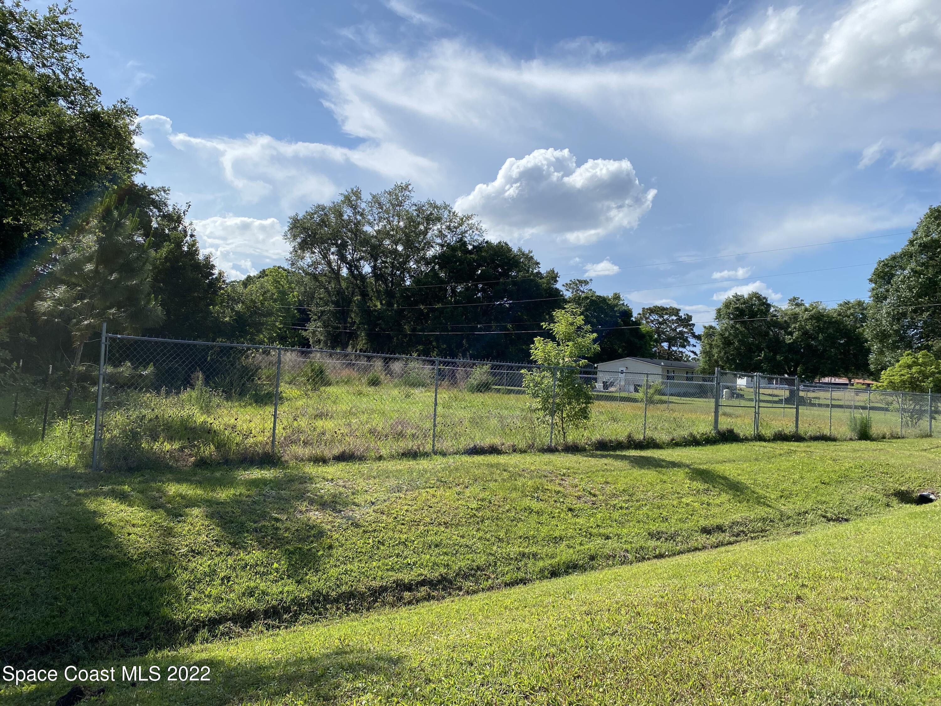 2736 Aein Road Orlando, FL 32817 - Photo 3 of 11 a view of a golf course with a lake