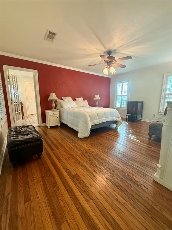 3420 Springfield Road Springtown, TX 76082 - Photo 25 of 38 a spacious bedroom with a bed and wooden floor