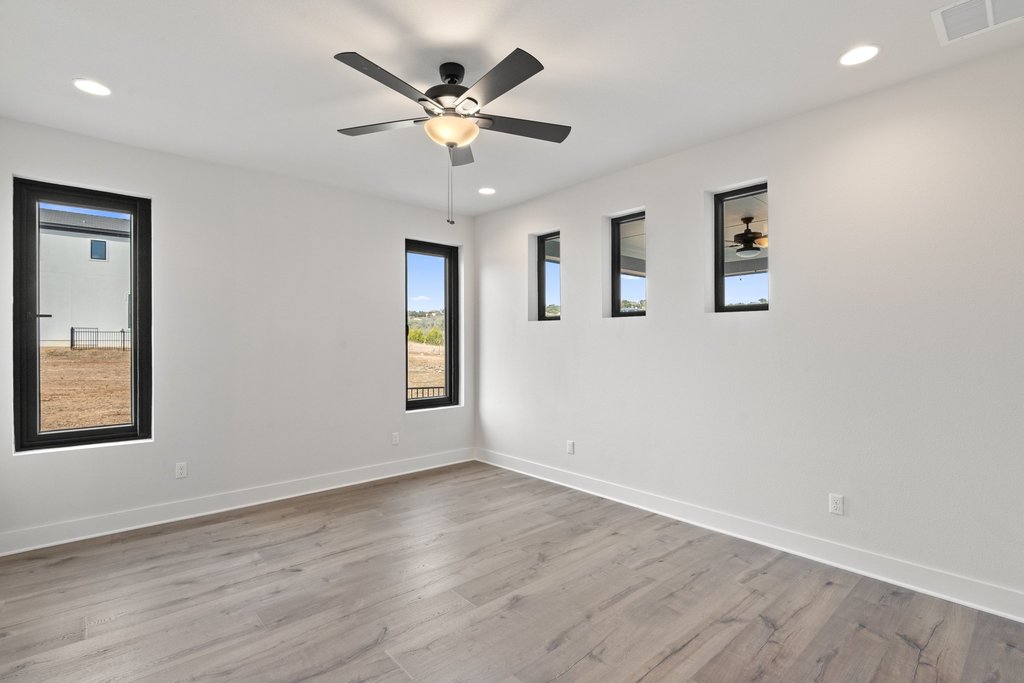 711 Paleface Ranch Road, Unit 9 Spicewood, TX 78669 - Photo 8 of 30 Spare room with light wood-type flooring, a ceiling fan, and recessed lighting