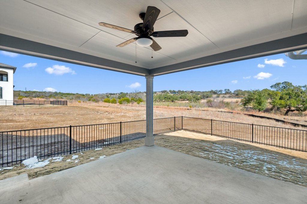 711 Paleface Ranch Road, Unit 9 Spicewood, TX 78669 - Photo 20 of 30 Fenced backyard with a patio area and a ceiling fan
