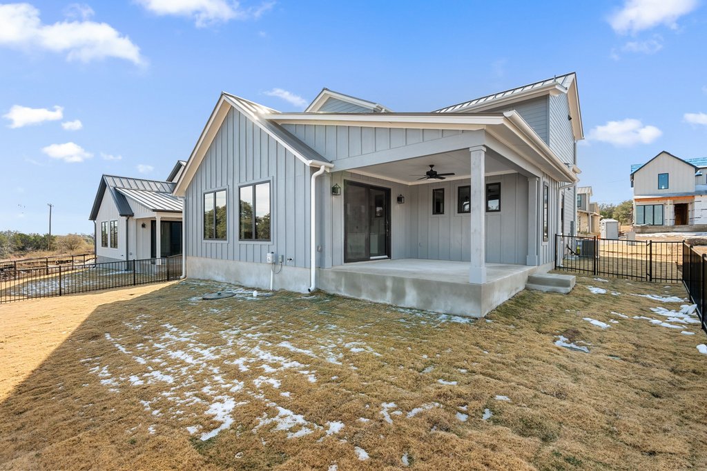 711 Paleface Ranch Road, Unit 9 Spicewood, TX 78669 - Photo 24 of 30 View of front of home with board and batten siding, ceiling fan, a standing seam roof, a metal roof, and a patio