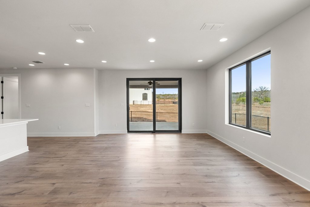 711 Paleface Ranch Road, Unit 9 Spicewood, TX 78669 - Photo 3 of 30 Unfurnished room featuring recessed lighting, light wood-style floors, and healthy amount of natural light