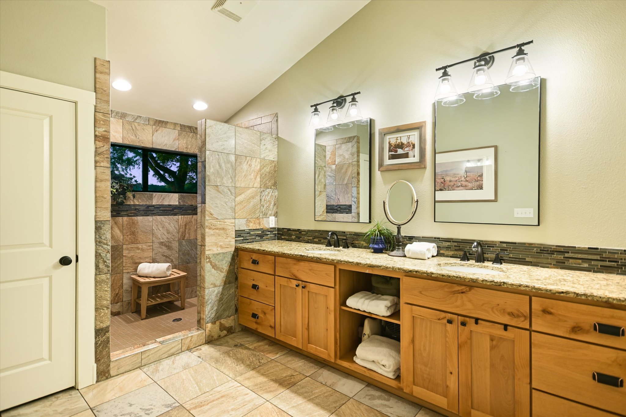 2411 Spoke Hollow Road Wimberley, TX 78676 - Photo 15 of 37 Granite counters and tiled shower create a refreshing primary bathroom retreat.