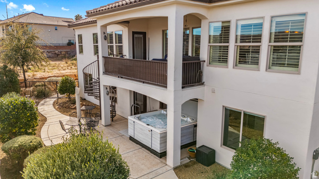 2311 South 1340 West St. George, UT 84770 - Photo 51 of 56 Back of house featuring a hot tub, a patio area, stucco siding, a balcony, and a tile roof