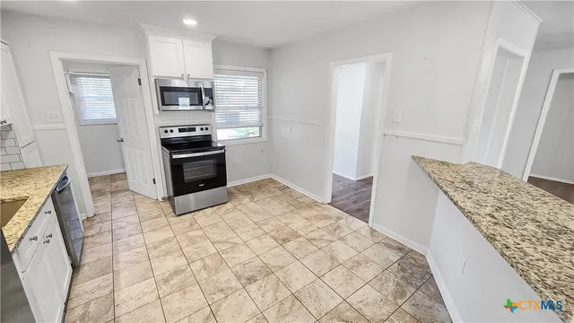 a kitchen with stainless steel appliances a refrigerator and a stove