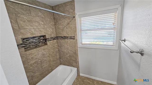 a bathroom with a shower and toilet