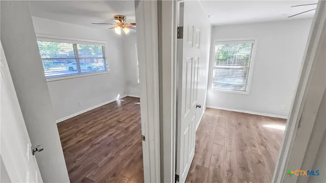 a view of livingroom with hardwood floor and a ceiling fan