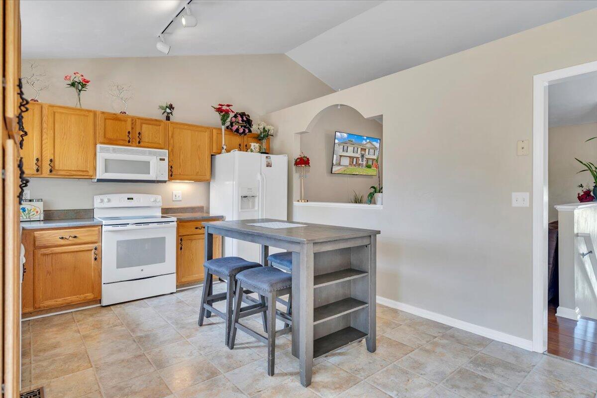 4751 Westvale Road Northeast Roanoke, VA 24019 - Photo 13 of 30 a kitchen with appliances cabinets and wooden floor