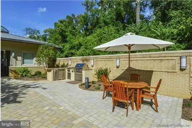 a view of a patio with table and chairs under an umbrella