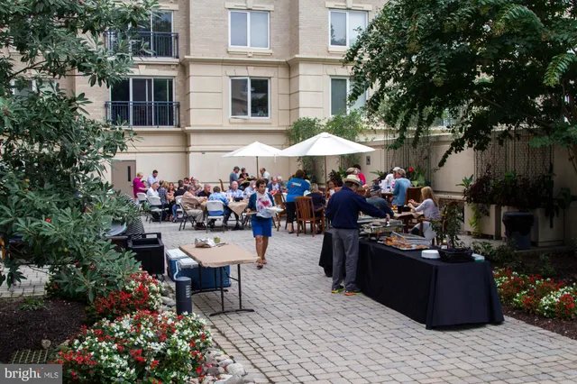 a group of people sitting in front of a house