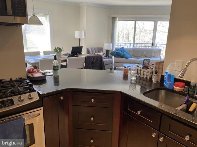 a kitchen with sink a stove and cabinets