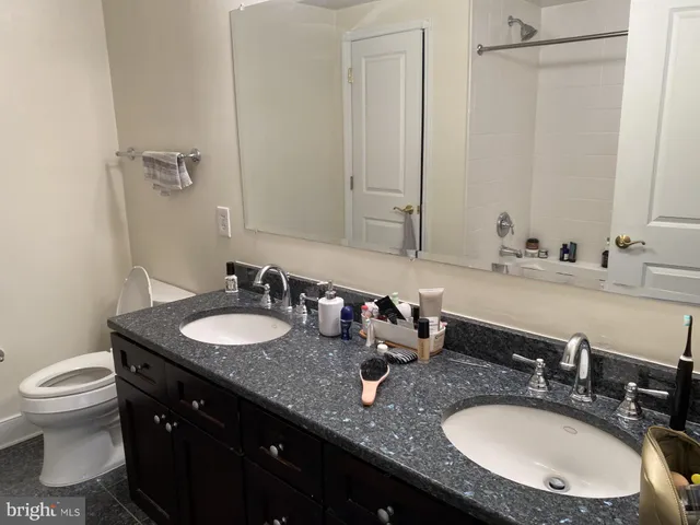 a bathroom with a double vanity sink and a mirror