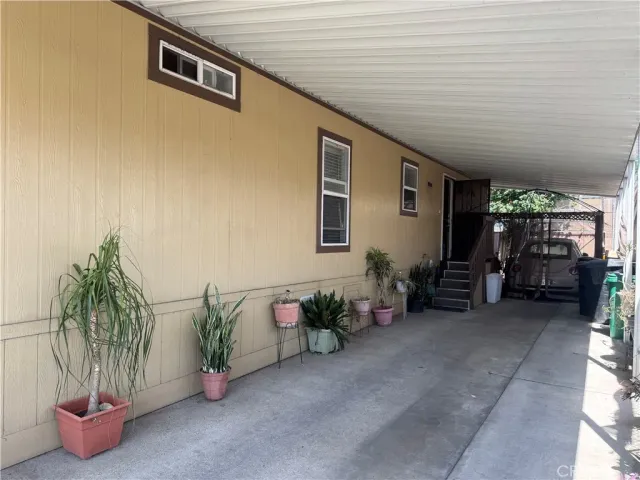 a backyard of a house with outdoor seating and plants
