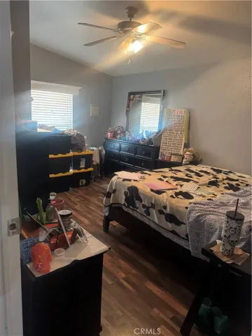 a bedroom with a bed and a computer on the desk