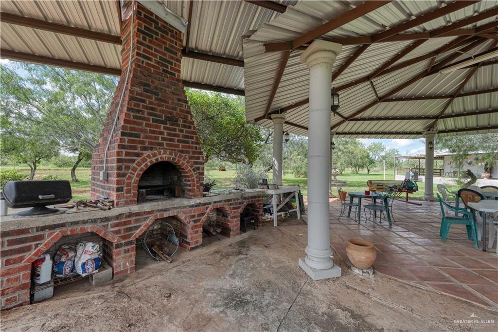 220 Delmita Road Delmita, TX 78536 - Photo 13 of 33 a living room with patio furniture and a fireplace