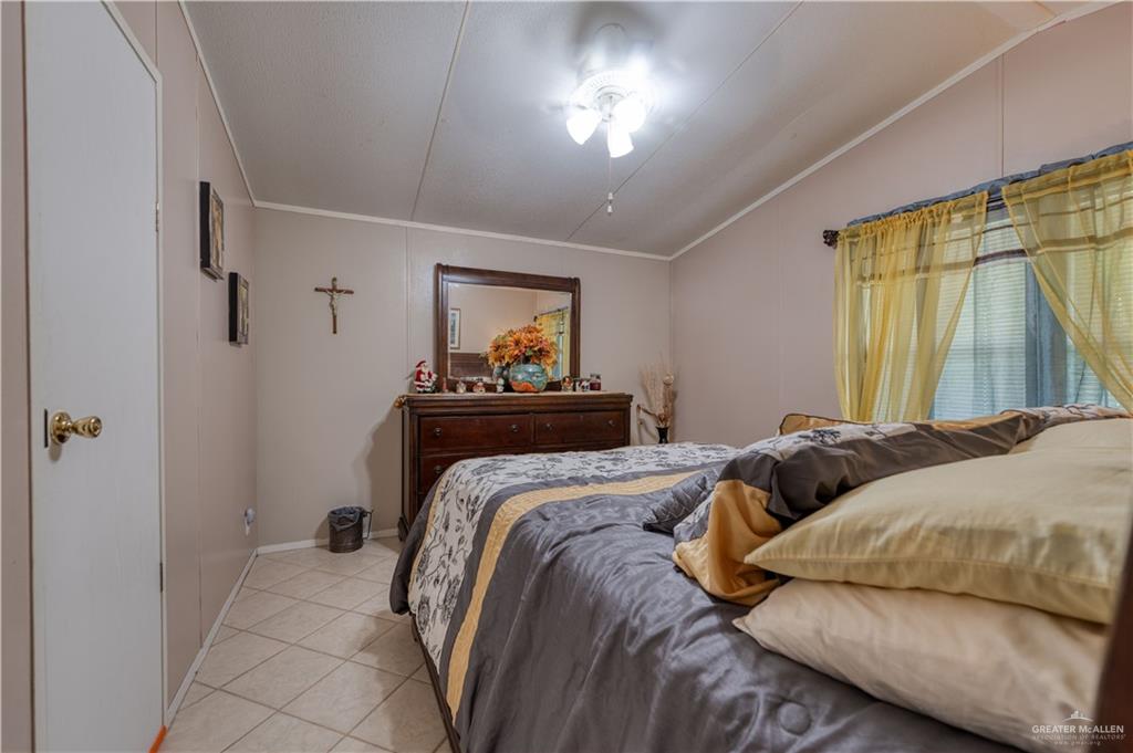 220 Delmita Road Delmita, TX 78536 - Photo 24 of 33 a bedroom with a bed and a painting on the wall