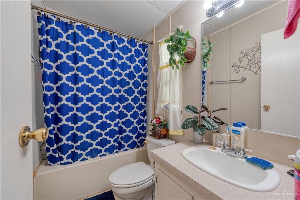 220 Delmita Road Delmita, TX 78536 - Photo 25 of 33 a bathroom with a sink toilet and mirror