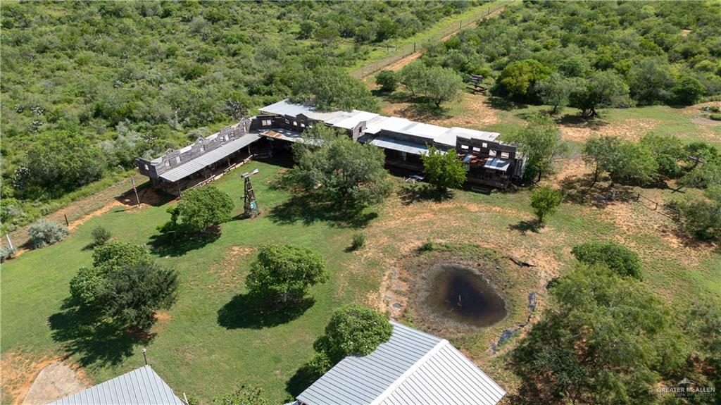 220 Delmita Road Delmita, TX 78536 - Photo 3 of 33 an aerial view of a house with a yard and greenery