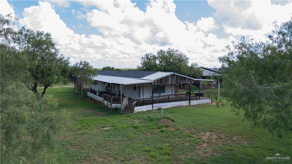 220 Delmita Road Delmita, TX 78536 - Photo 8 of 33 a view of a house with a big yard and large trees