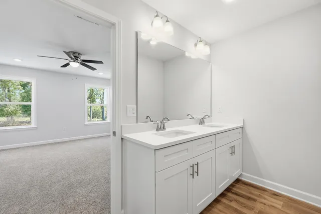 a bathroom with a sink a vanity and a mirror