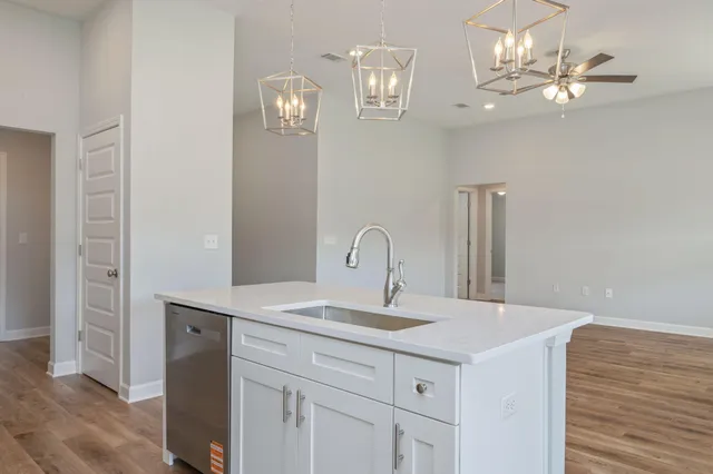 a kitchen with a sink and a chandelier