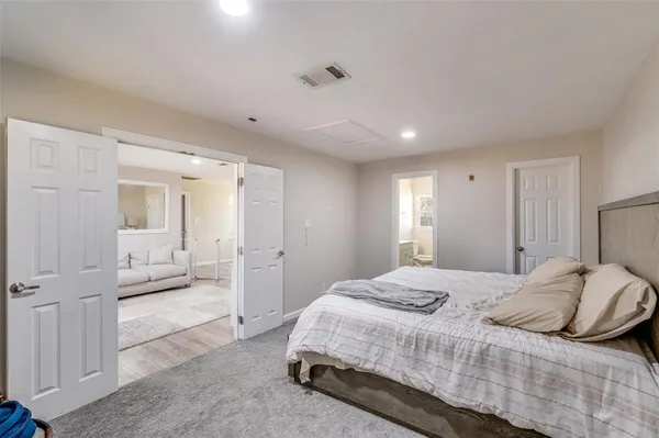 a spacious bedroom with a bed and a couch