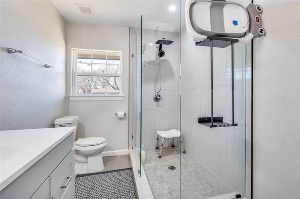 a bathroom with a toilet sink and shower