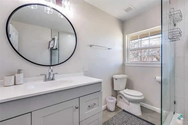 a bathroom with a toilet a sink and a mirror
