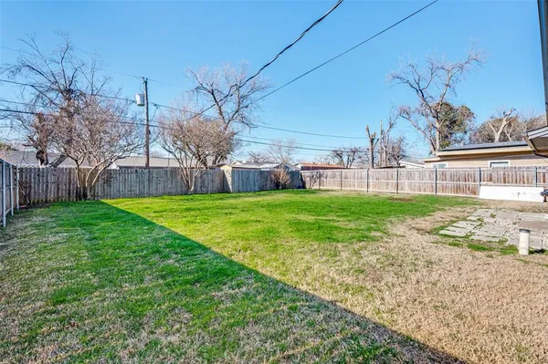a view of a house with a yard and sitting area