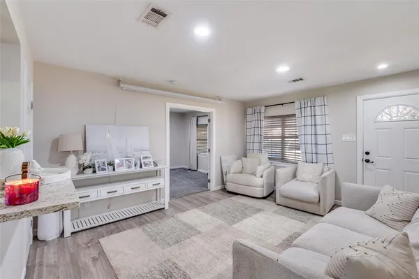 a living room with furniture and white walls