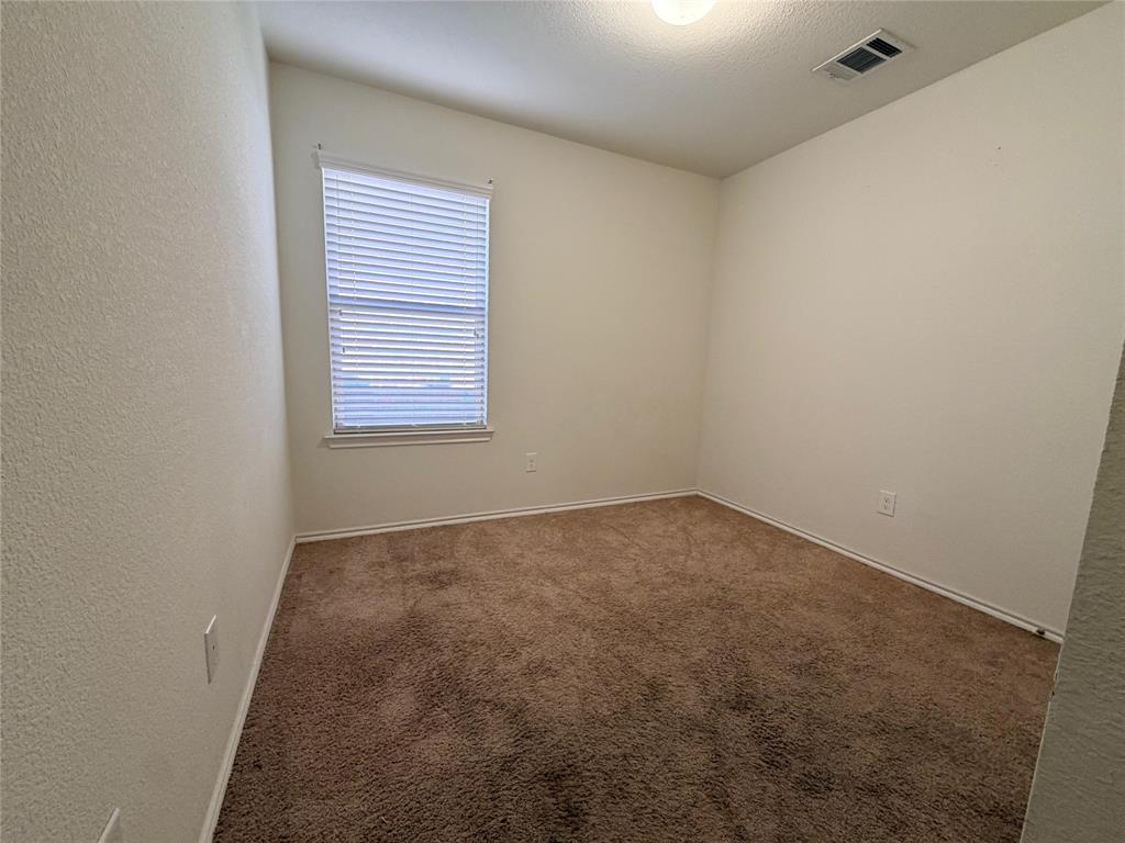 2203 Vance Drive Forney, TX 75126 - Photo 14 of 23 Unfurnished bedroom featuring light carpet and a textured ceiling