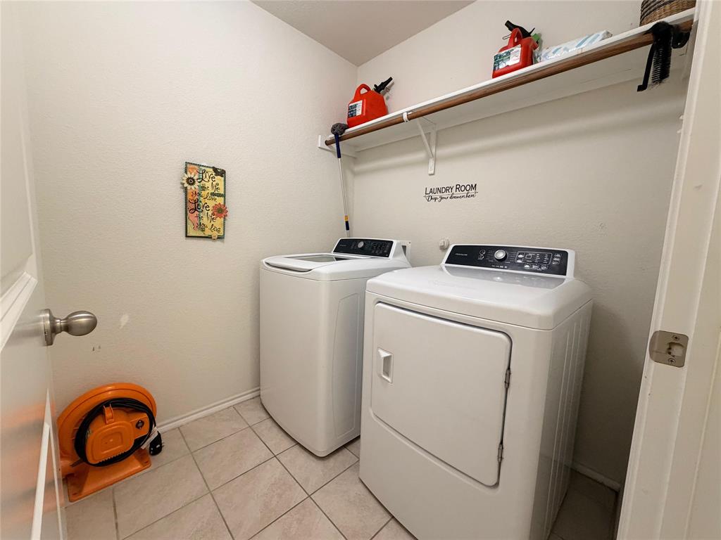 2203 Vance Drive Forney, TX 75126 - Photo 18 of 23 Washroom featuring light tile patterned floors and washing machine and clothes dryer