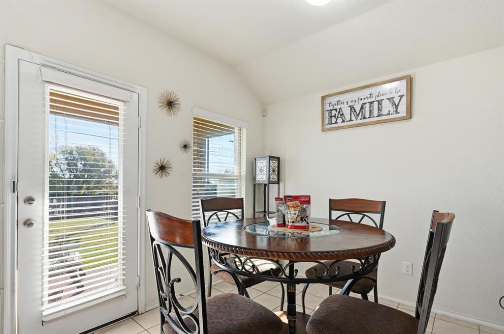 2203 Vance Drive Forney, TX 75126 - Photo 6 of 23 Dining area featuring light tile patterned flooring and vaulted ceiling