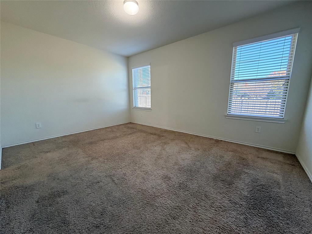 2203 Vance Drive Forney, TX 75126 - Photo 10 of 23 Unfurnished bedroom featuring light carpet and a textured ceiling