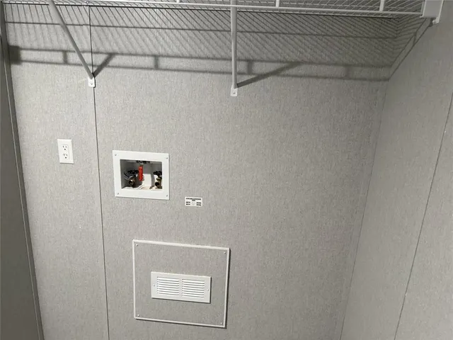 a kitchen with kitchen island granite countertop a sink a stove and a refrigerator