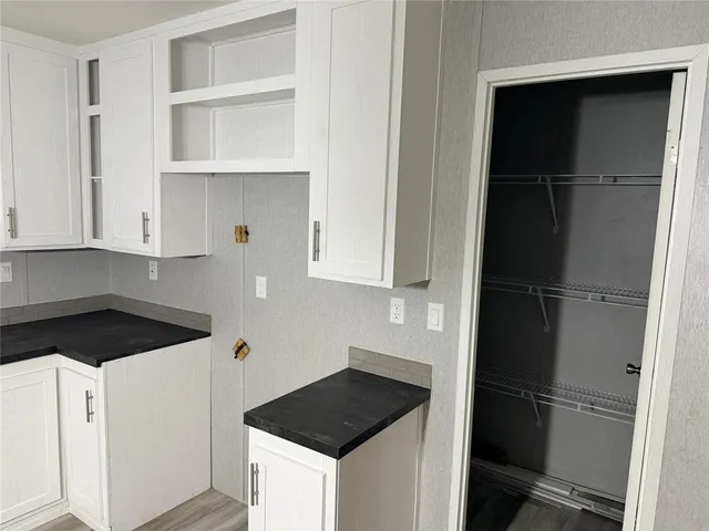 a kitchen with a refrigerator and cabinets