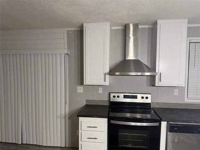 a kitchen with a stove and a cabinet