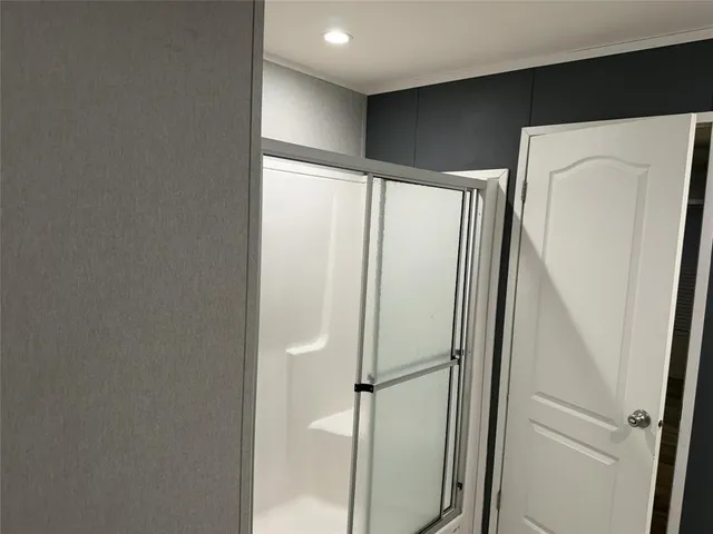 a white bath tub sitting in a bathroom next to a toilet