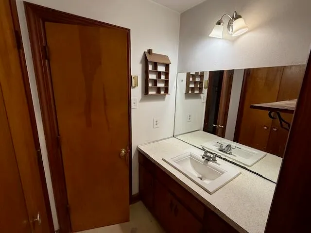 a bathroom with a sink vanity and a mirror