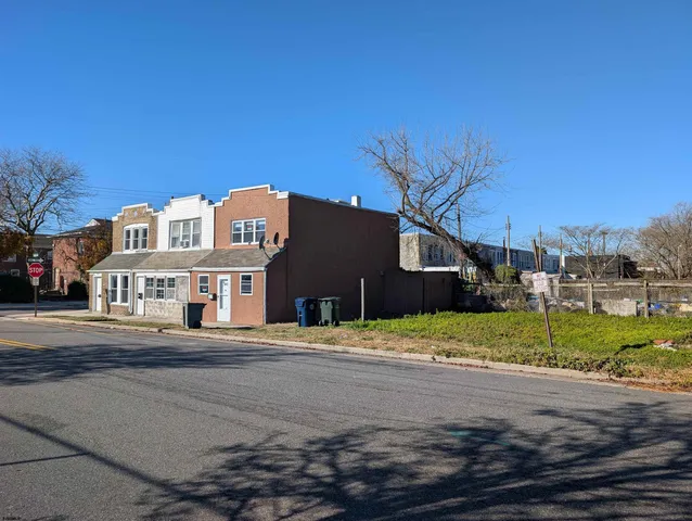 a view of road with large house