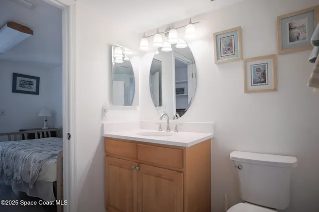 a bedroom with a bed and a mirror